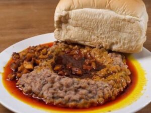 Agege Bread and Ewa Agoyin – Soft bread served with mashed beans and spicy sauce