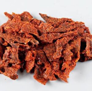 Kilishi, must-try Nigerian street food, featuring thinly sliced, spicy beef jerky, perfect for snacking