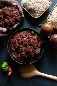 Ofada Rice and Ayamase Stew, must-try Nigerian street foods, offering a spicy and satisfying meal